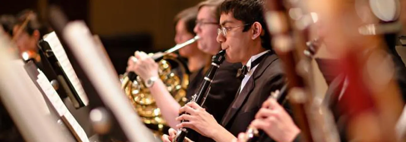 students in black tie playing in the orchestra