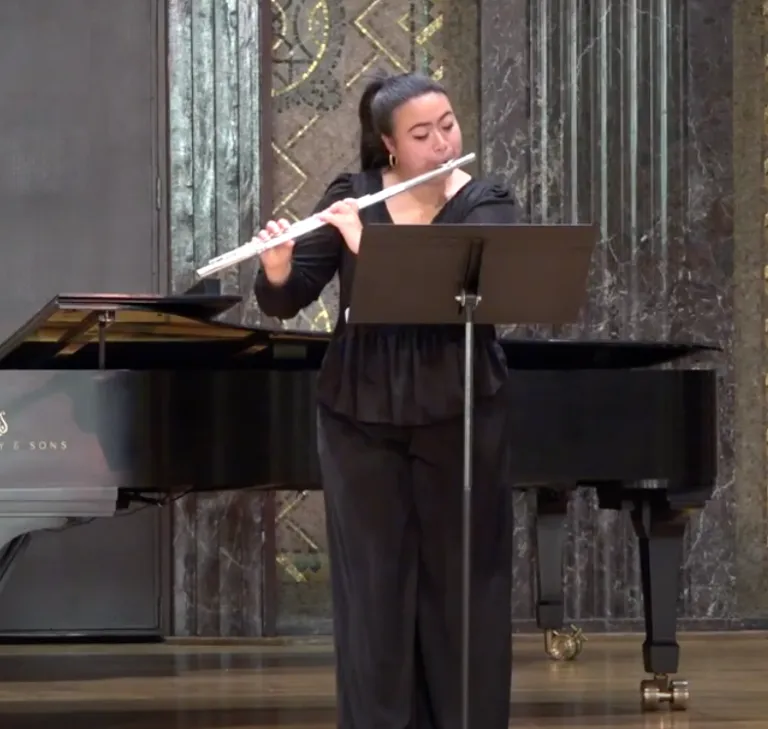 Undergraduate Lillie Kang plays the flute in competition