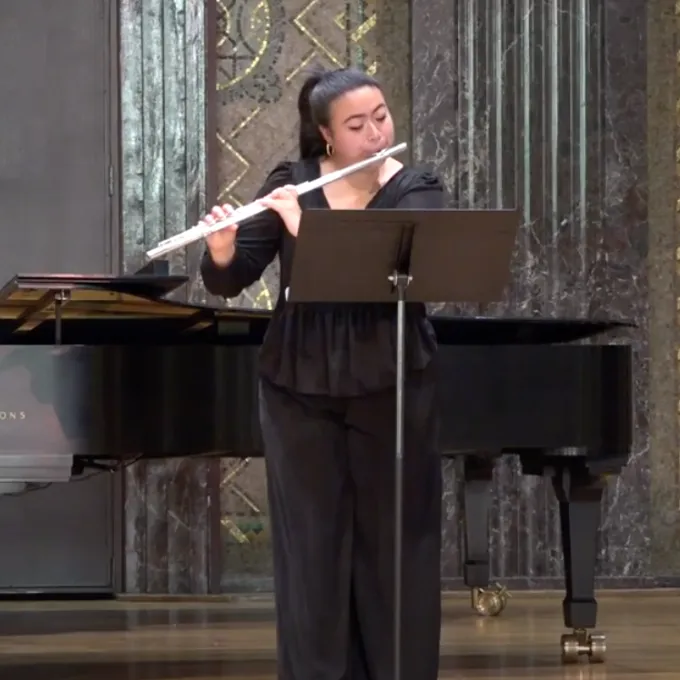 Undergraduate Lillie Kang plays the flute in competition